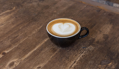 cup of coffee on wooden table