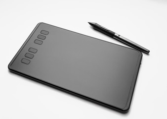 Graphic tablet with pen on white background. Tool for designers and illustrators.