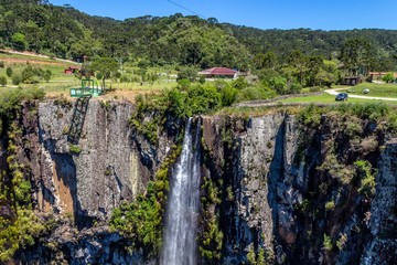 Avencal waterfall. A beautiful panoramic view with lots of green vegetation and mountains at the top of the waterfall