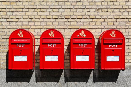 Aarhus, Denmark - August 1, 2016: Red Danish letterboxes on a wall