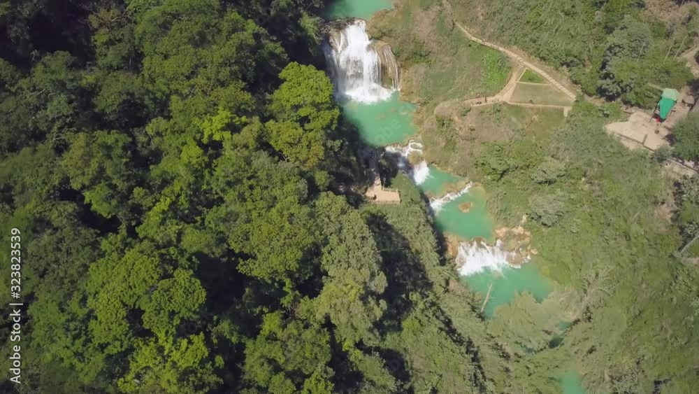 Wall mural Aerial view to powerful waterfall with blue natural pools