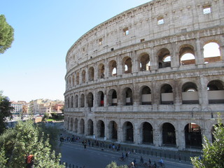 Fototapeta na wymiar Exterior view of the Colosseum, also known as the Flavian Amphitheater, located in Rome, Italy with blue sky in the background 