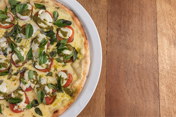 Pizza on the brown wooden table