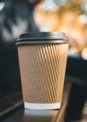 cup of coffee on the bench in a park