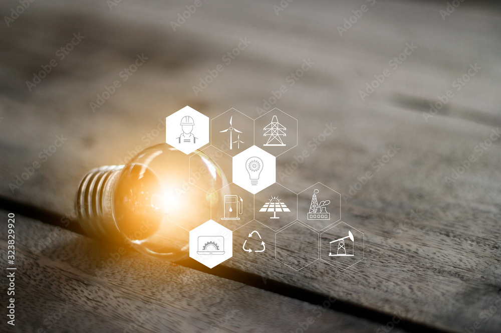 Canvas Prints small light bulb glowing on table with icons energy sources for renewable, sustainable development. 