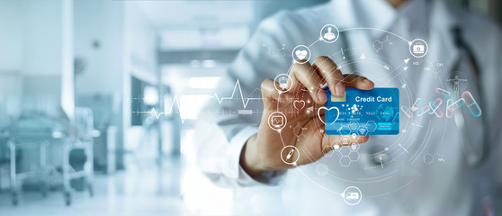 Healthcare business, Doctor holding credit card and icon healthcare medical, medicine, banking and financial, data and business growth graph on global network connection in hospital background.