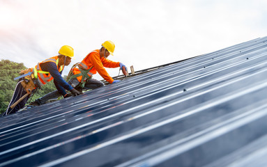 Roof repairman working on the working at height.Professional industrial climber in helmet and...