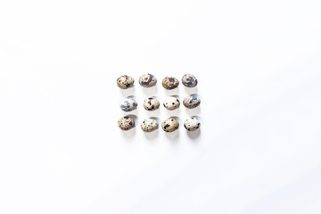 Quail eggs arrangement on the white background