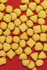 View from above to sweet mini cookies on the red background