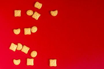 View from above to sweet mini cookies on the red background