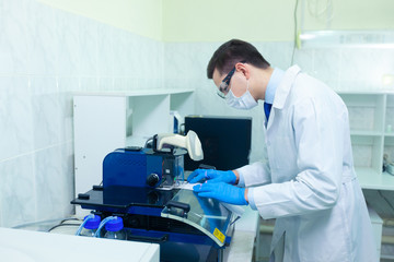 DNA laboratory. The expert puts the human DNA into the database using advanced laboratory technologies