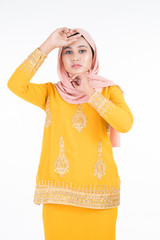 Obraz premium Beautiful female Muslim model in modern kurung and hijab, a modern lifestyle apparel for Muslim women isolated on white background. Beauty and hijab fashion concept. Full length portrait