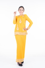 Obraz premium Beautiful female Asian model in various poses wearing modern kurung, a Malaysian traditional wear isolated on white background. Beauty and fashion concept. Full length portrait
