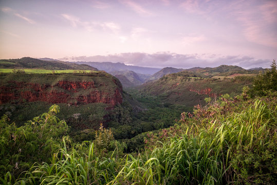 Grand Canyon With Red Clay Dirt In Kauai Hawaii Paradise With Purple Sky Of Dusk In The Background