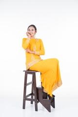 Fototapeta na wymiar Beautiful female Asian model in various poses wearing modern kurung, a Malaysian traditional wear isolated on white background. Beauty and fashion concept. Full length portrait