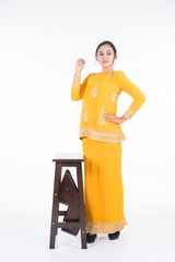 Beautiful female Asian model in various poses wearing modern kurung, a Malaysian traditional wear isolated on white background. Beauty and fashion concept. Full length portrait