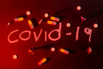 Covid-19 Coronavirus Concept  -  writing on black board with creative lighting. shallow depth of...