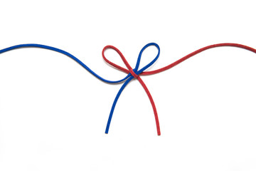 red and blue ribbon isolated on white background. two colors chamois string tied in a bow. 
