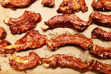 Lots of pork ribs cooked in barbecue sauce and sprinkled with sesame seeds. Traditional western...