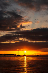 Fototapeta na wymiar Beautiful sunset in Islamorada in the Florida Keys with boats silhouetted against the dramatic sky..
