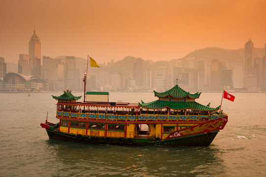 Chinese traditional ferry is running at Victoria harbor in Hong Kong, China.
