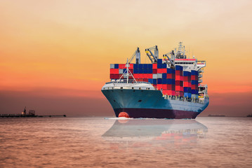 Fototapeta premium International Container Cargo ship sailing in the Ocean, Freight Transportation, Shipping, Nautical Vessel on sunset background.