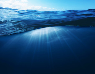 Fototapeta premium Underwater Deep Blue Sea and Sunlight Ray shining under the sea Summer background concept
