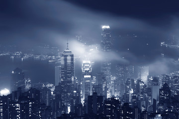 Misty night view of Victoria harbor in Hong Kong city