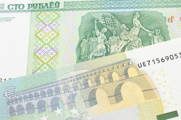 A close up image of a five Euro note from the European Union eurozone with a one hundred ruble note from Belarus