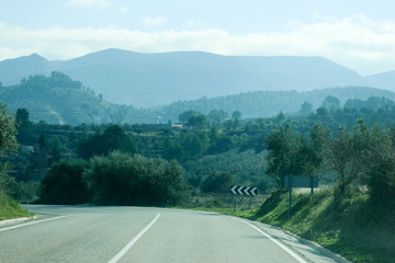 road in the mountains in winter morning haze, Spain