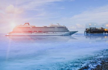 Cruise ship, large luxury white cruise ship liner on blue sea water and twilight background.