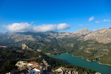 Fototapeta na wymiar Panoramic view to beautiful azure Guadalest reservoir lake surrounded by mountains from the castle, Spain