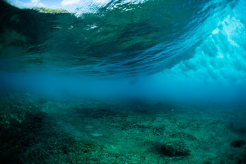 Fototapeta na wymiar Ocean wave rolling and breaking over the coral reef
