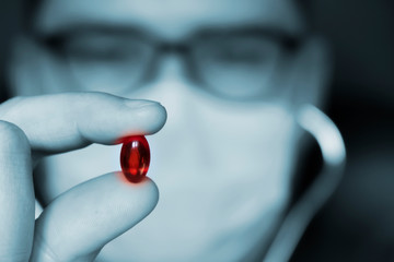 Doctor is holding vaccine pill concept. Medical care concept. Coronavirus vaccine concept Selective...