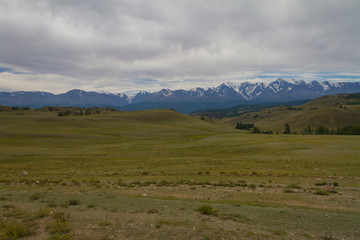 Panoramic view of a mountain valley summer. Altai mountains. Summer dark day.