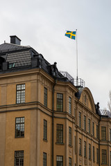 Swedish state flag on the roof of a building.