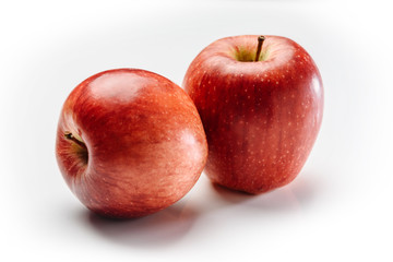 Two big red apples on a white background.