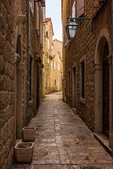 Fototapeta na wymiar Sun-lit stone streets in the old town