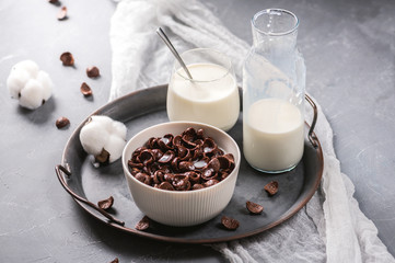 Milk with chocolate corn flakes cereal in bowl