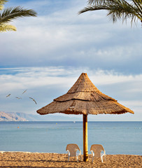 Relaxing facilities on sandy beach in Eilat - famous tourist resort and recreation city in Israel
