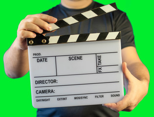 open clapper board, numbering in hands on a green background