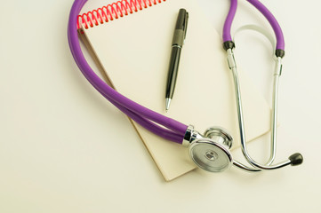 Stethoscope pen with notebook on a white background