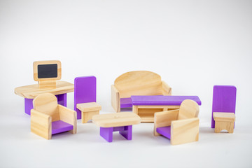 Tiny wooden toy furniture isolated on white. Old toy seat on a white background.