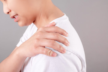 Asian people wear white shirts, suffering from shoulder pain. Isolated the background, health concept