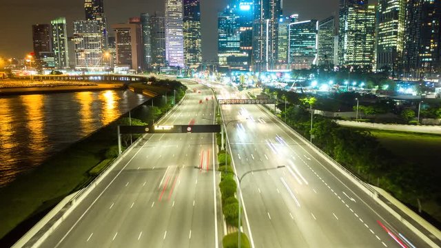 Hyperlapse aerial view flying of Road highway along to the night cityscape skyline at Singapore.