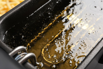 Hot cooking oil in deep fryer, closeup