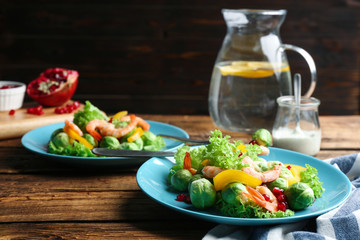 Tasty salad with Brussels sprouts served on wooden table