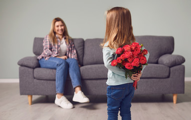 Happy mother's day. Daughter gives mom flowers.