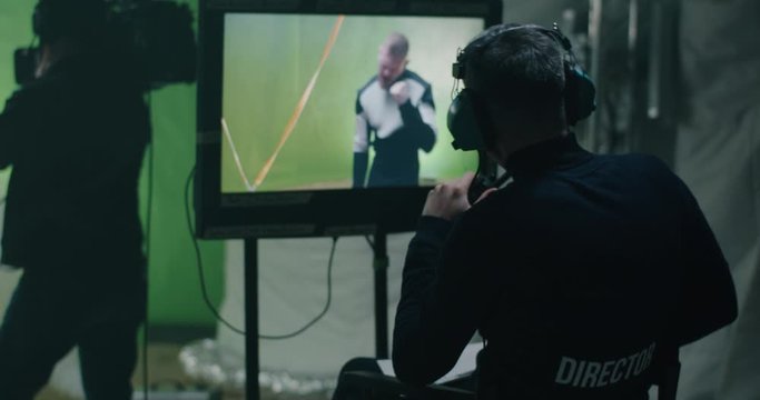 Director giving instructions and watching the scene on monitor