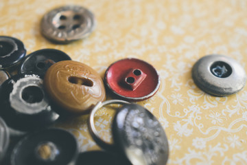 metal buttons on yellow background
